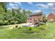 Charming brick home with two car garage, walk out deck, and lush green lawn at 205 Rosedale Ln, Matthews, NC 28105