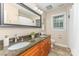 This bathroom includes a granite countertop, double sinks, and warm colored cabinets at 205 Rosedale Ln, Matthews, NC 28105