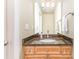 Stylish half bathroom features a wood vanity with a granite countertop and silver fixtures at 205 Rosedale Ln, Matthews, NC 28105