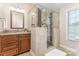 The beautiful bathroom features a glass shower, granite countertops, and dark wood cabinets at 205 Rosedale Ln, Matthews, NC 28105