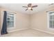 The bedroom has neutral carpet, ceiling fan, and two windows at 205 Rosedale Ln, Matthews, NC 28105