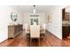 Elegant dining room with hardwood floors, decorative molding, and modern chandelier at 205 Rosedale Ln, Matthews, NC 28105