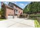 Two-story brick home with a two car garage, deck, fenced backyard, and manicured lawn at 205 Rosedale Ln, Matthews, NC 28105