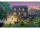 Exterior shot of a brick home with a fenced-in backyard, patio, and a two-car garage at 205 Rosedale Ln, Matthews, NC 28105