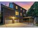 Exterior shot of a brick home with a fenced-in backyard, patio, and a two-car garage at 205 Rosedale Ln, Matthews, NC 28105