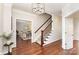 Foyer with hardwood floors, staircase with wooden banister, and decorative light fixture at 205 Rosedale Ln, Matthews, NC 28105