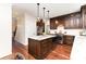 Charming kitchen featuring an island, granite countertops, stainless steel appliances, and ample dark wood cabinetry at 205 Rosedale Ln, Matthews, NC 28105