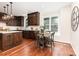 Kitchen featuring dark wood cabinets, stainless steel appliances, and hardwood floors at 205 Rosedale Ln, Matthews, NC 28105