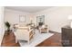 Well-lit living room featuring hardwood floors, neutral furniture, and stylish decor at 205 Rosedale Ln, Matthews, NC 28105