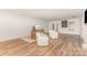 Spacious living area featuring hardwood floors, neutral walls, and two accent chairs at 205 Rosedale Ln, Matthews, NC 28105