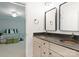 En suite bathroom with double sink, vanity, and view into the bedroom at 2324 Kingsmill Ter, Charlotte, NC 28270