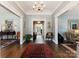 Grand foyer with detailed millwork, hardwood floors, and elegant lighting at 2324 Kingsmill Ter, Charlotte, NC 28270