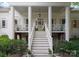 Elegant porch with columns, complemented by manicured landscaping and a welcoming staircase at 2324 Kingsmill Ter, Charlotte, NC 28270
