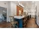 Kitchen with exposed brick wall and white countertop island and seating for six at 2324 Kingsmill Ter, Charlotte, NC 28270