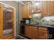 Wet bar with granite counters, under cabinet lighting and wine cellar door at 2324 Kingsmill Ter, Charlotte, NC 28270