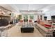 Finished basement living room with stone fireplace and large windows showcasing the backyard at 2324 Kingsmill Ter, Charlotte, NC 28270