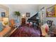Cozy living room featuring a piano, rug, and comfortable seating at 2324 Kingsmill Ter, Charlotte, NC 28270