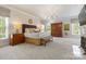 Spacious main bedroom with chandelier, natural light, and hardwood furniture at 2324 Kingsmill Ter, Charlotte, NC 28270