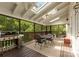 A spacious covered porch with a table and chairs and a view of the trees at 2324 Kingsmill Ter, Charlotte, NC 28270