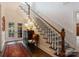 Elegant staircase with carpet runner and views to the outside patio at 2324 Kingsmill Ter, Charlotte, NC 28270