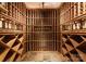 Spacious, custom wine cellar with wood shelving for storing wine bottles at 2324 Kingsmill Ter, Charlotte, NC 28270