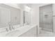 Bright bathroom with dual sinks, marble countertops, and a glass-enclosed shower at 3011 Mckee Rd, Charlotte, NC 28270