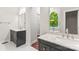 Bathroom featuring double vanities with granite countertops, tile flooring, and a view to the soaking tub at 3011 Mckee Rd, Charlotte, NC 28270