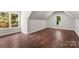 Bright bedroom with hardwood floors, recessed lighting, and two windows at 3011 Mckee Rd, Charlotte, NC 28270