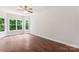 Light filled bedroom features beautiful hardwood floors and multiple large windows at 3011 Mckee Rd, Charlotte, NC 28270