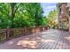 Large deck with wood railing offers plenty of space for outdoor entertaining at 3011 Mckee Rd, Charlotte, NC 28270