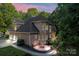 Stunning brick home featuring a fire pit, multi-car garage, and manicured landscaping at 3011 Mckee Rd, Charlotte, NC 28270