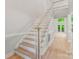 Bright foyer featuring elegant staircase with light wood treads and white risers and trim at 3011 Mckee Rd, Charlotte, NC 28270