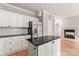Kitchen with stainless steel appliances, granite countertops and central island; opens to living room and fireplace at 3011 Mckee Rd, Charlotte, NC 28270