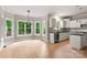 Spacious kitchen with white cabinets, black granite countertops and a central island adjacent to the dining area at 3011 Mckee Rd, Charlotte, NC 28270