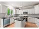 Bright kitchen features white cabinetry, granite countertops, stainless steel appliances, and an island with pendant lights at 3011 Mckee Rd, Charlotte, NC 28270