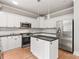 Kitchen featuring white cabinetry, stainless steel appliances, granite countertops and island with pendant lights at 3011 Mckee Rd, Charlotte, NC 28270