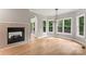 Bright living room featuring fireplace, hardwood flooring, and views of outdoor deck at 3011 Mckee Rd, Charlotte, NC 28270