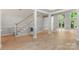 Bright open floor plan featuring elegant staircase, soaring columns, and access to outside deck at 3011 Mckee Rd, Charlotte, NC 28270