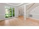Bright living room featuring natural light, an elegant staircase, and hardwood flooring at 3011 Mckee Rd, Charlotte, NC 28270