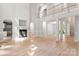 Bright living room featuring an open floor plan, fireplace, and balcony overlooking living space at 3011 Mckee Rd, Charlotte, NC 28270