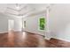 Main bedroom featuring hardwood floors, tray ceilings, and natural light from large windows at 3011 Mckee Rd, Charlotte, NC 28270