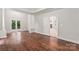 Main bedroom with hardwood floors, a tray ceiling, access to a balcony, and an ensuite bathroom at 3011 Mckee Rd, Charlotte, NC 28270