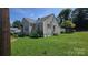 Exterior view showing a well-maintained lawn, a detached structure, and the home's siding under a sunny sky at 3418 York Hwy, Gastonia, NC 28052