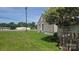 Exterior showcasing a compact backyard with a sloped lawn, partial fencing, and the home's siding at 3418 York Hwy, Gastonia, NC 28052