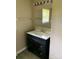 Bathroom with dark vanity, white countertop, oval sink, and large mirror at 3484 S Hwy 127 Hwy, Hickory, NC 28602