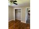 Bedroom featuring hardwood floors, ceiling fan, closet, and access to kitchen at 3484 S Hwy 127 Hwy, Hickory, NC 28602