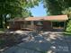 Charming one-story brick home with a ramp, carport and mature trees creating a welcoming curb appeal at 3484 S Hwy 127 Hwy, Hickory, NC 28602