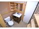 Bathroom featuring a toilet, vanity, mirror with built-in shelves, and unfinished wood trim at 416 E Union St, Marshville, NC 28103