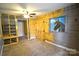 A bedroom featuring faux wood paneling, a horse painting, blue walls, and a built in closet with shelves and barn doors at 416 E Union St, Marshville, NC 28103