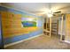 Bedroom with wooden shelving, an abstract wall mural, and a ceiling fan at 416 E Union St, Marshville, NC 28103